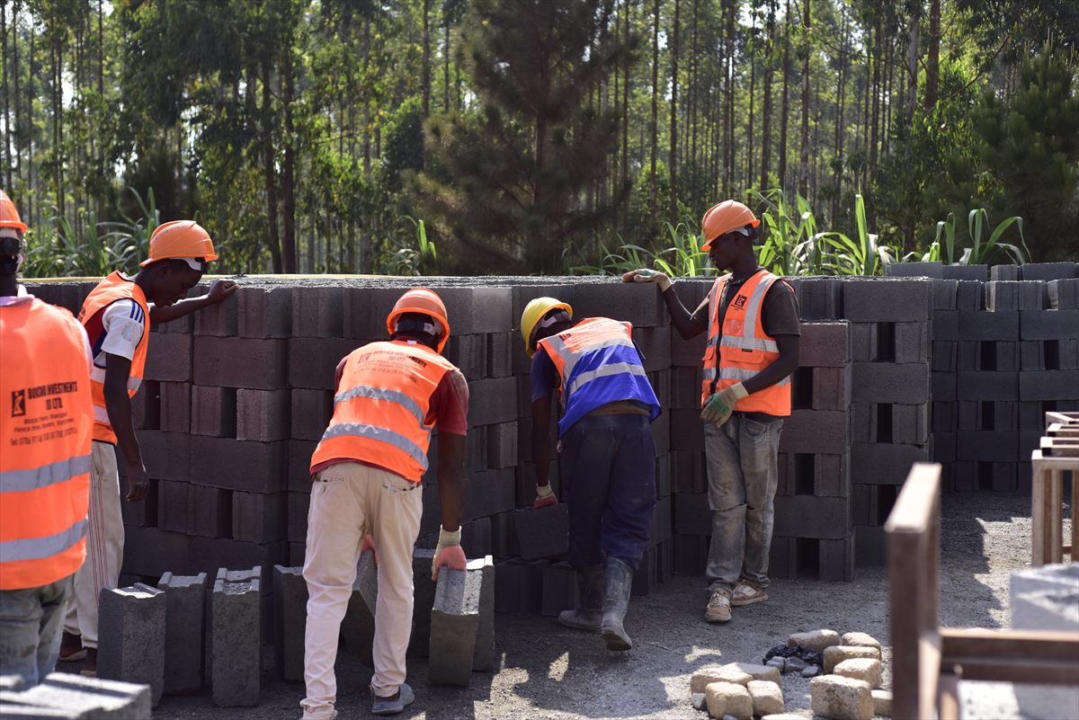 BOKSWA workers stacking freshly cast concrete blocks