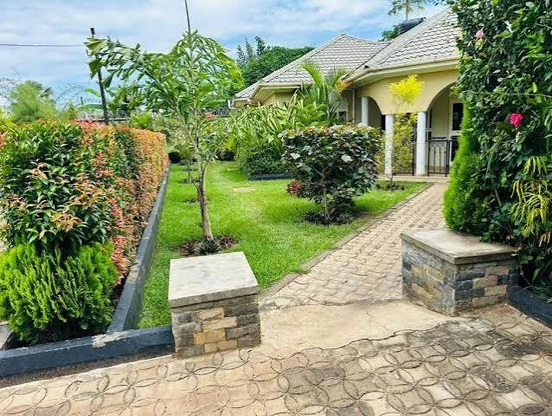 Paved path running through a landscaped garden