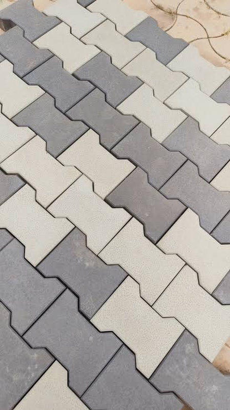 Bone-profile pavers laid in alternating grey and white courses