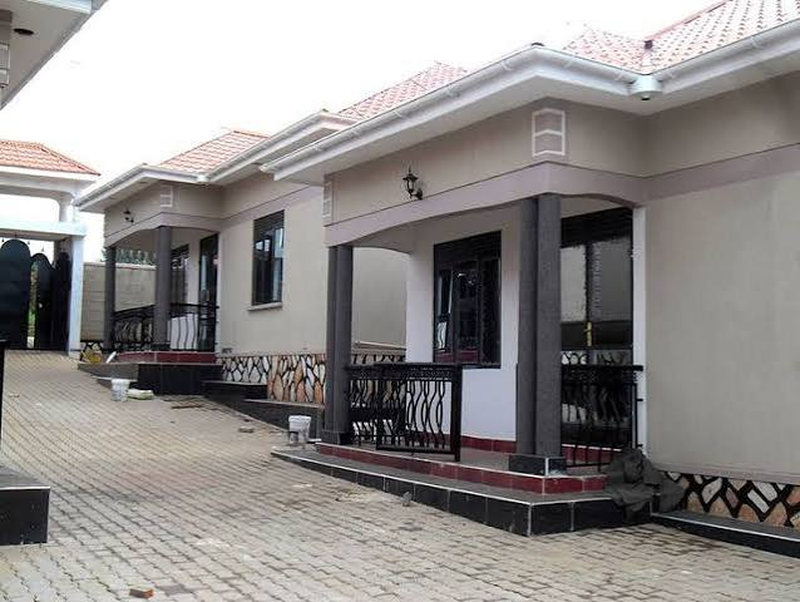 Terrace of completed homes with a paved forecourt